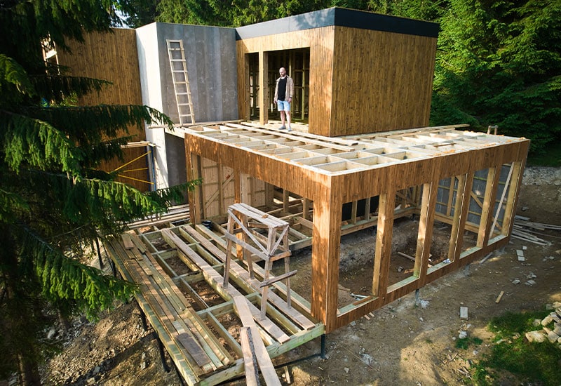 Exterior of home with large addition under construction