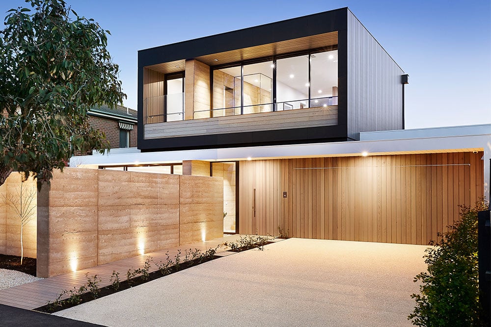 House with second story addition with large windows